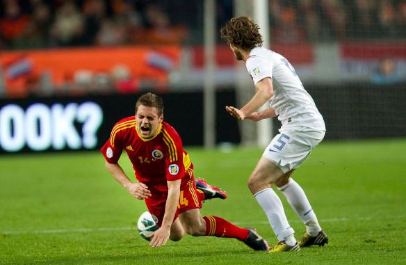 Blind of the Netherlands fights for the ball with Popa of Romania during their World Cup qualifying soccer match in Amsterdam